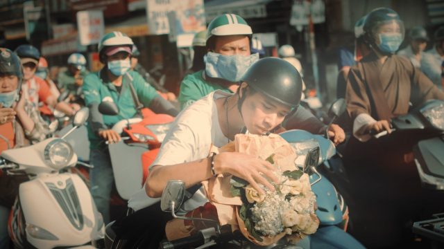 thinh suy with flowers on bike