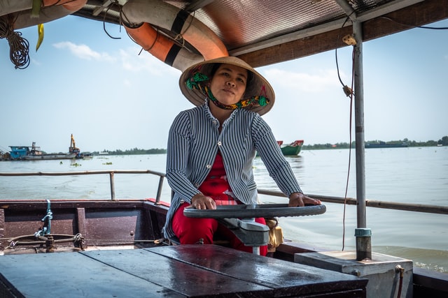 boat woman in mekong vietnam